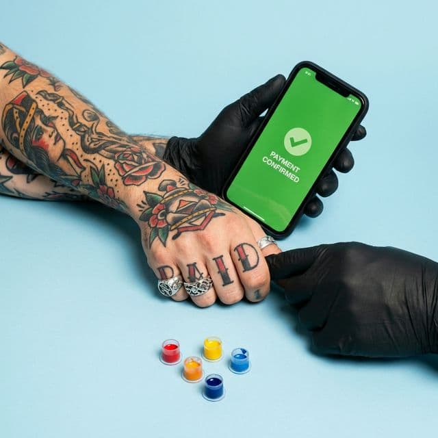 A client confirming a booking request in a tattoo studio